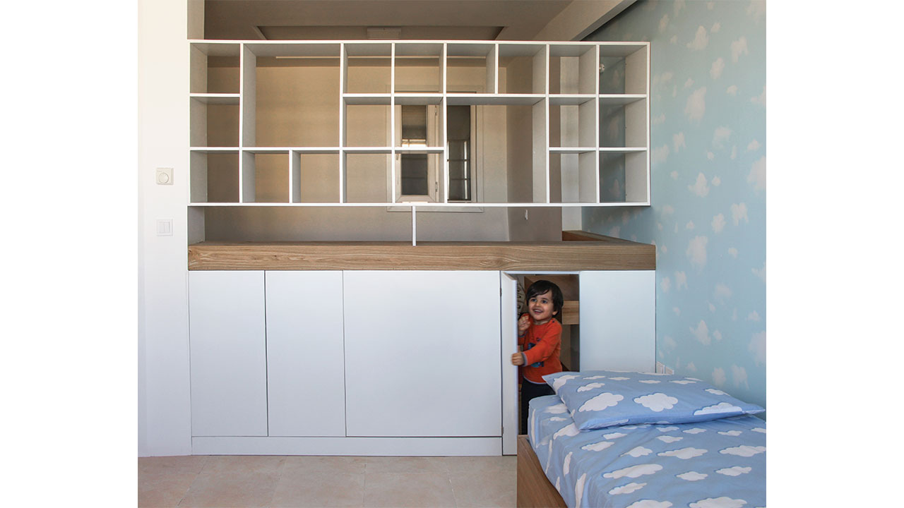 Kids room interior design for a boy - Box Shelves used as Space Separator containing mini kid door