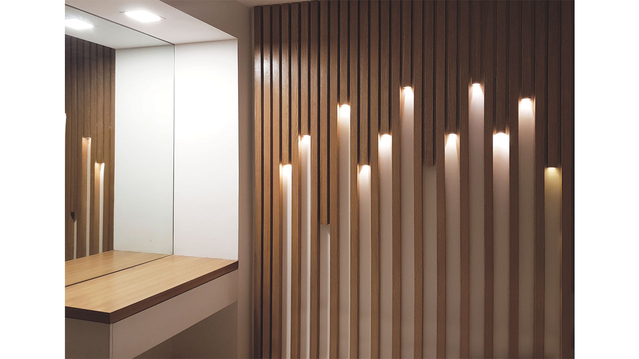 Constructed Bedroom Interior Design with Random Vertical Wooden Slats with lighting beside minimal mirror